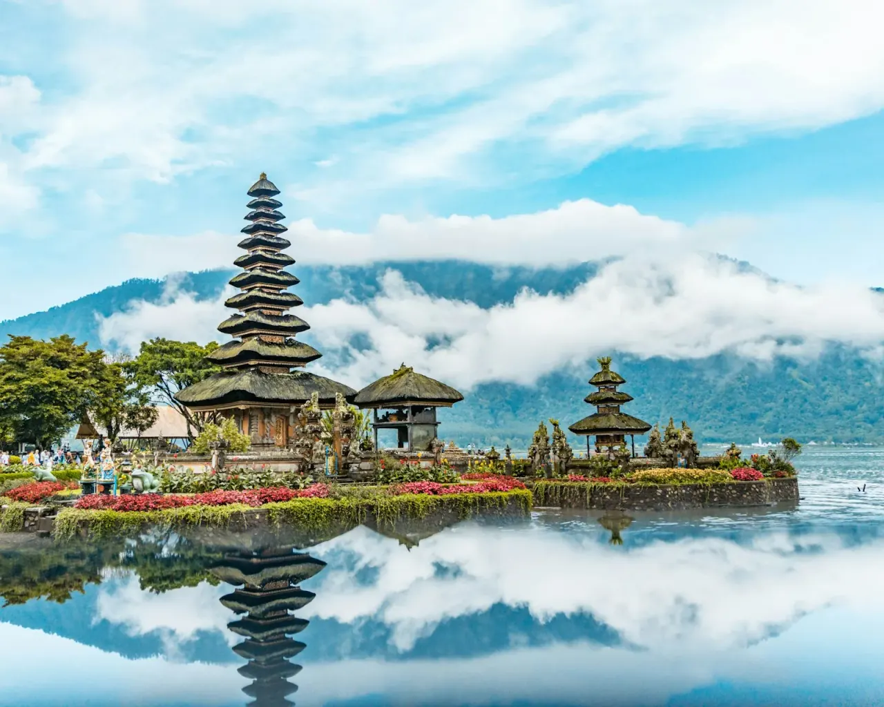 Stone gateway and pagoda of a traditional Balinese temple at golden hour