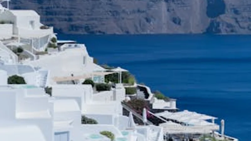 Greek island white buildings blue accents over the Aegean