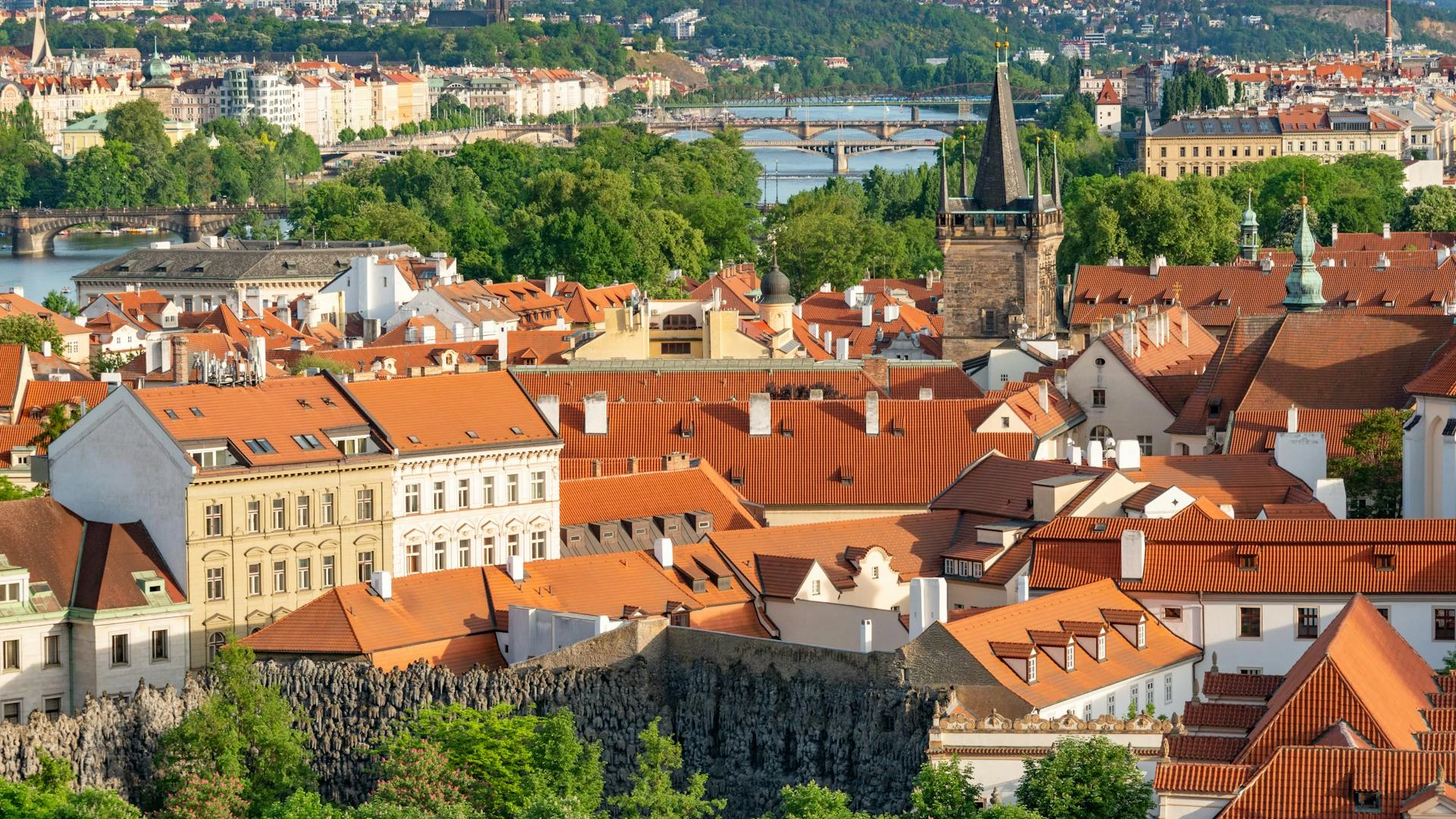 Prague red rooftop panorama with Charles Bridge and castle — boutique hotel guide