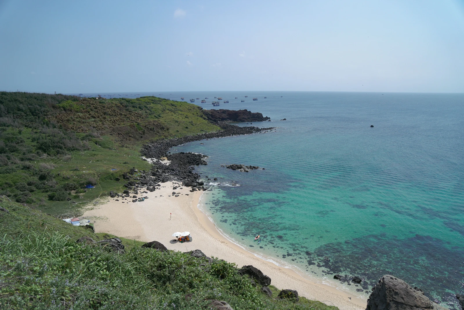Turquoise water and a rocky green headland along Quy Nhon's coastline, central Vietnam