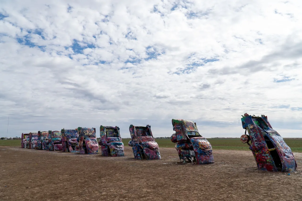Ten graffiti-covered Cadillacs buried nose-first in a field at Cadillac Ranch in Amarillo, Texas