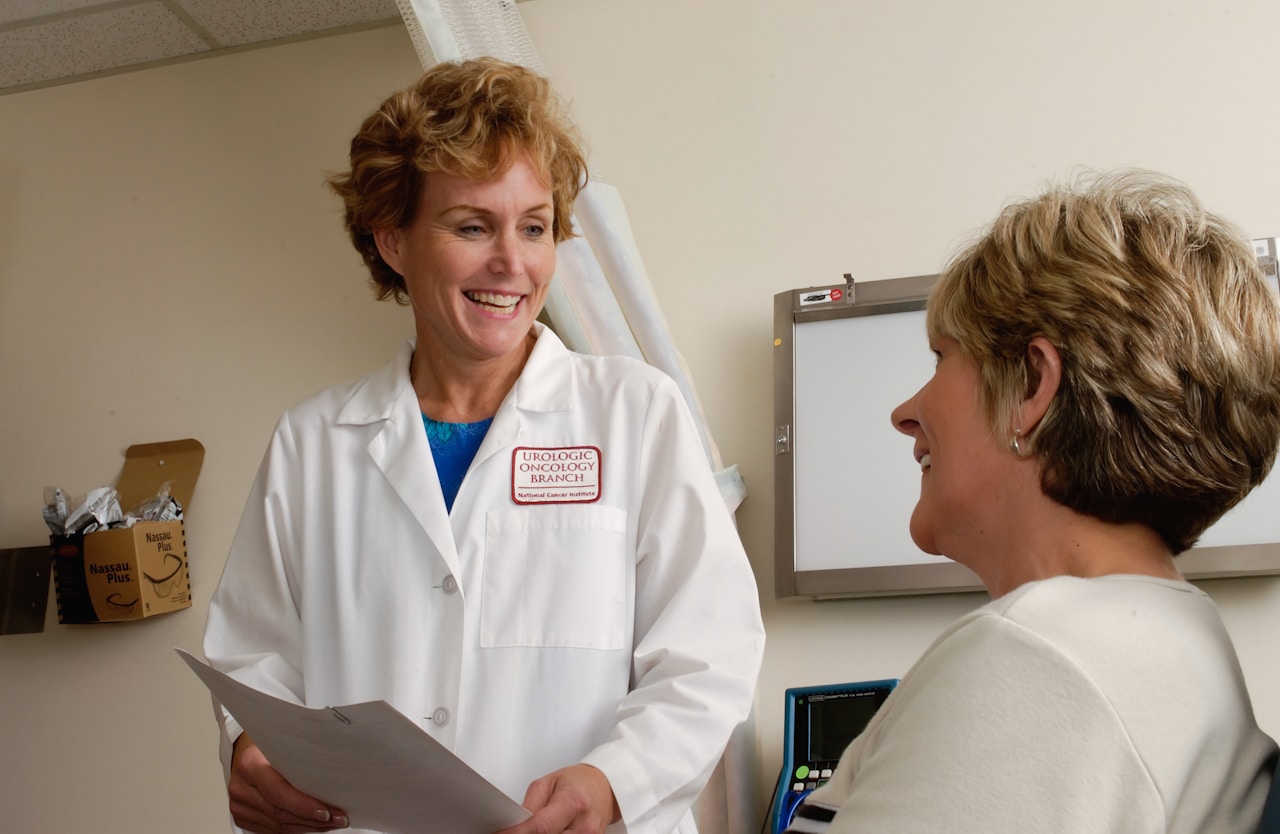 Intensive care nurse monitoring patient equipment in modern hospital ICU unit