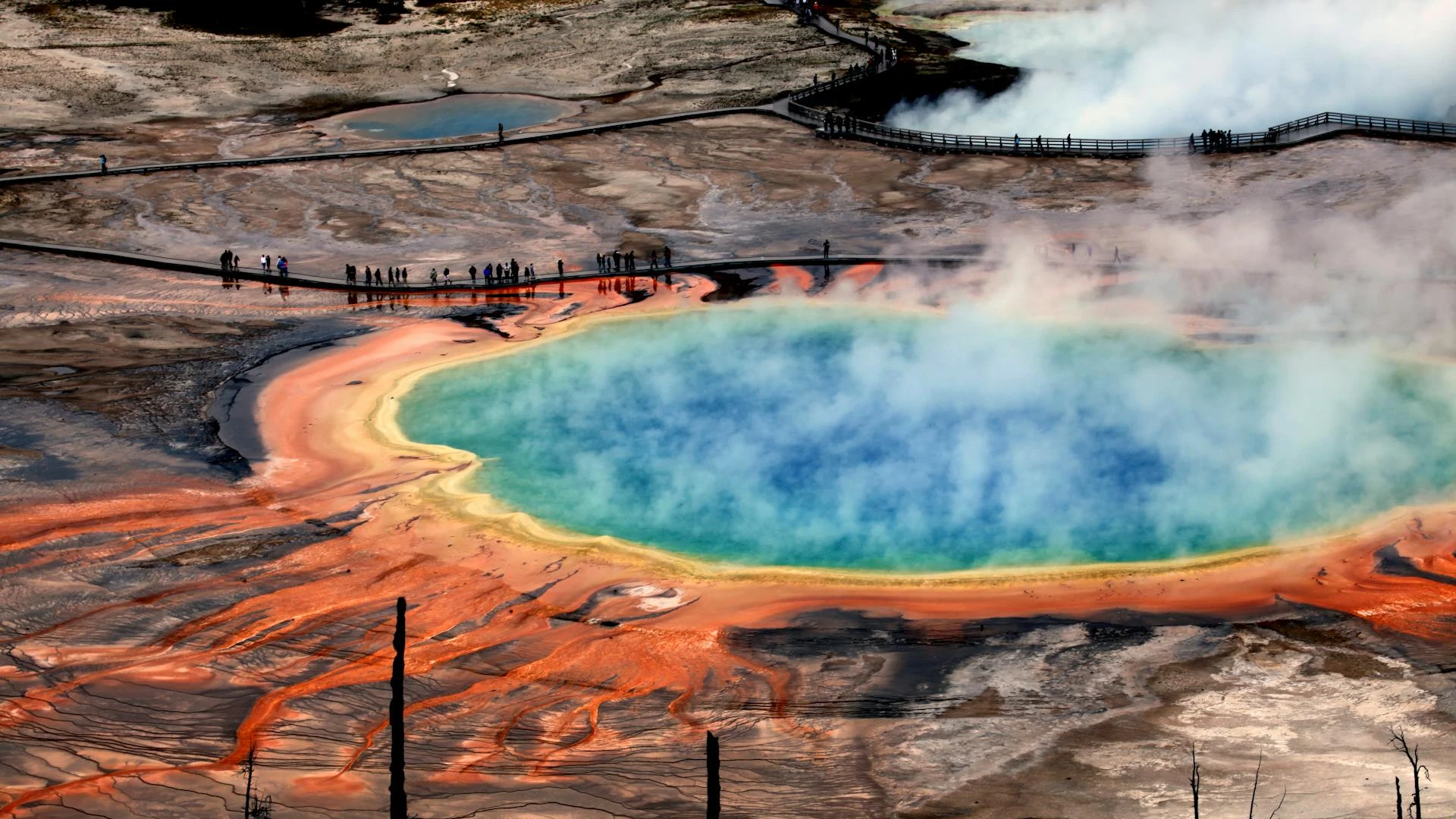 Aerial view of Grand Prismatic Spring's vivid colours and rising steam