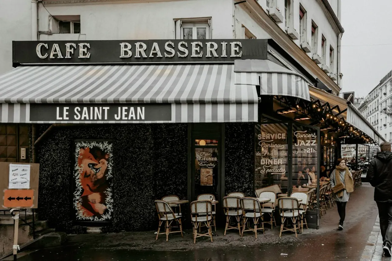 Quiet Paris café terrace at morning with marble-topped tables